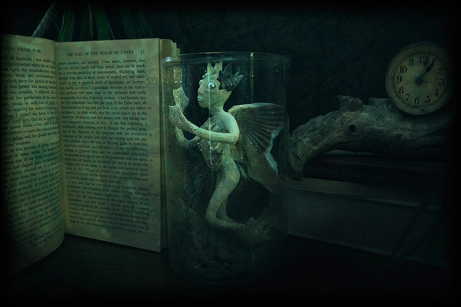 Surreal underwater creature sculture living in a glass reading ancient books